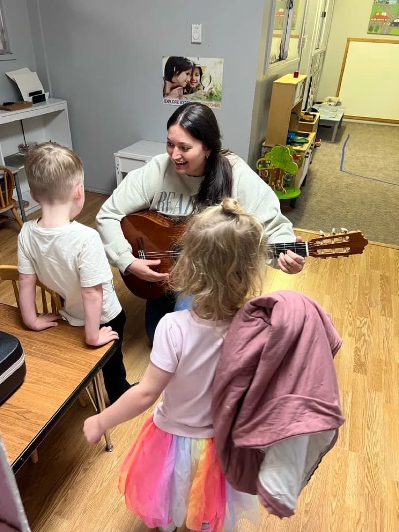 Teacher showing how a guitar makes music